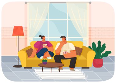 Oturma odasındaki kanepede oturan çift, erkek ve kız patlamış mısır yiyor ve konuşuyorlar.