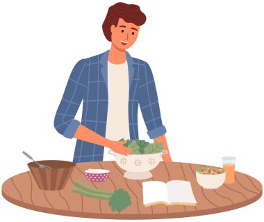 Adam yemek tarifleriyle aşçılık kitabı okuyor. Erkek karakter vejetaryen salatası hazırlıyor.