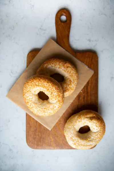 Three Bagels Sesame Seeds Wooden Cutting Board Marble Kitchen Worktop — Stok Foto