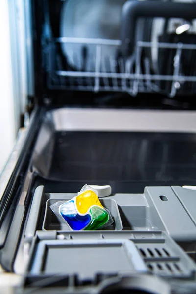 Comprimido de lavagem detergente em uma máquina de lavar louça aberta. — Fotografia de Stock