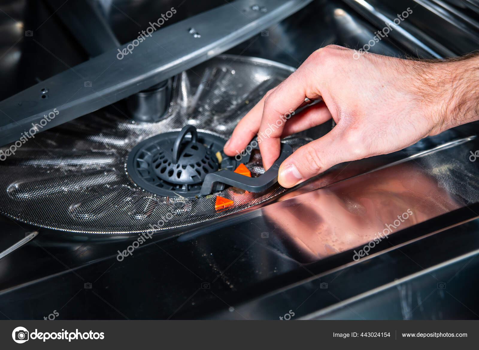 Male hand pulling a filter out of the dishwasher Stock Photo by ©jaczi