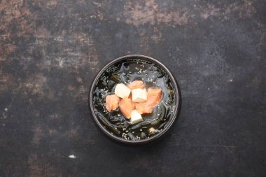 Top view of a traditional Japanese soup with salmon. The misoshiru.