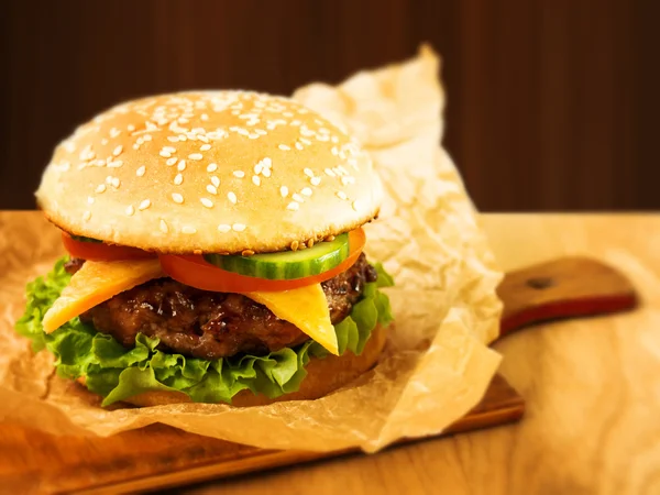 Juicy Burger on a wooden Board — Stock Photo, Image