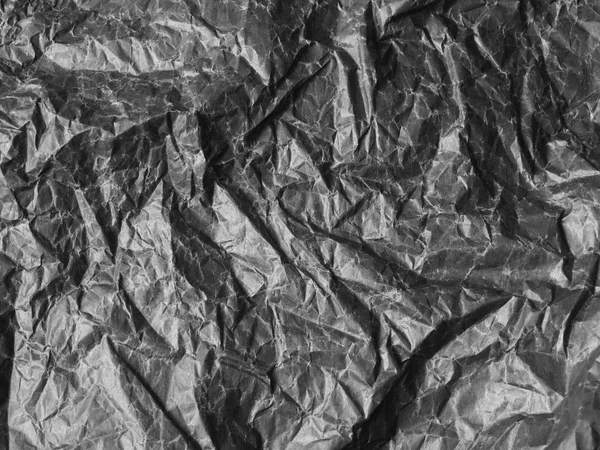 A crumpled sheet of paper black