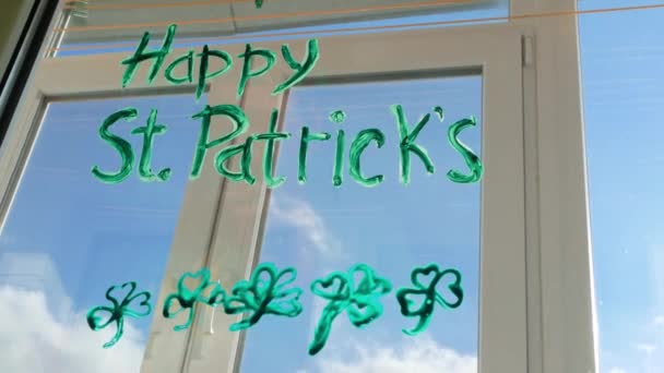 聖パトリックの日の男を描く緑の3つの葉のシャムロック室内 お祝いの家の装飾 隔離された家族のレジャーを描く 父は窓ガラスにクローバーの葉を描きます 家のコンセプトを保つ New Normal — ストック動画