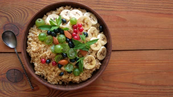 Wholegrain Oatmeal Porridge Fresh Berries Fruits Nuts Mint Leaves Child — Stock Video