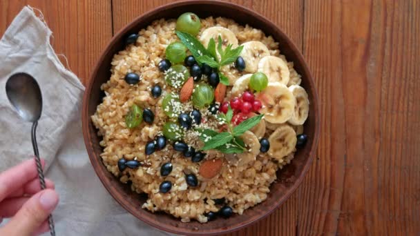 Wholegrain Oatmeal Porridge Fresh Berries Fruits Nuts Mint Leaves Sesame — Stock Video