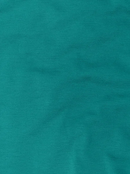 Turquoise jersey fabric matte texture top view. Blue knitwear background. Fashion color trendy clothes. Website backdrop text sign design. Abstract aqua marine wallpaper sea green textile surface.