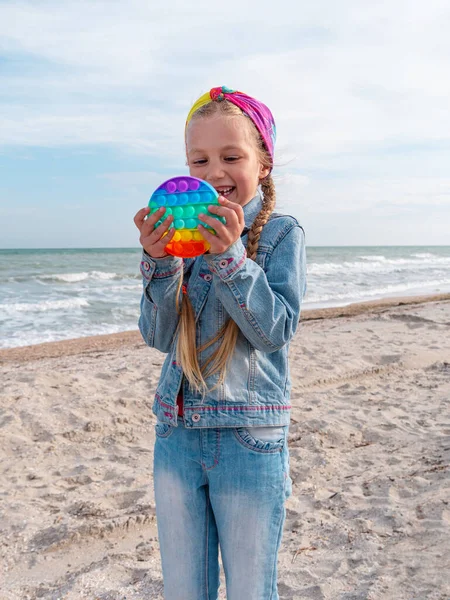 Bambino Felice Con Arcobaleno Pop Esso Giocattolo Divertirsi Sulla Spiaggia — Foto Stock