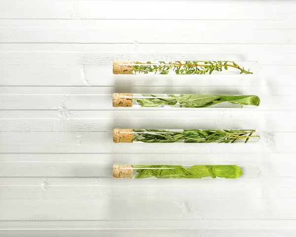 Test tubes with herbs with horizontal lines from top to bottom. — Stock Photo, Image