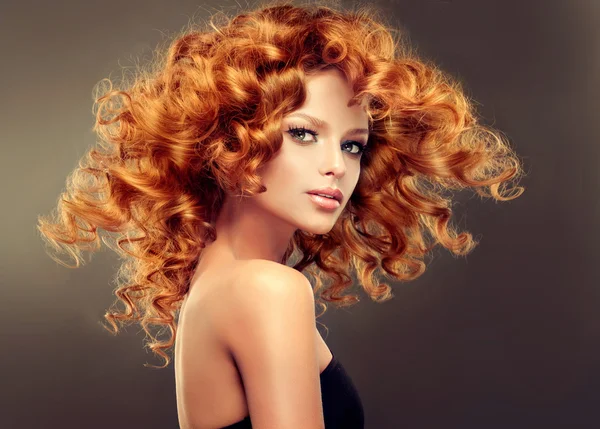 Redhead woman  with  curly hair Royalty Free Stock Photos