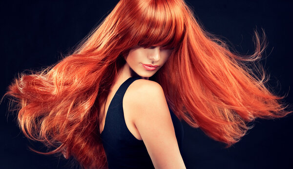 Girl with beautiful and shiny red hair