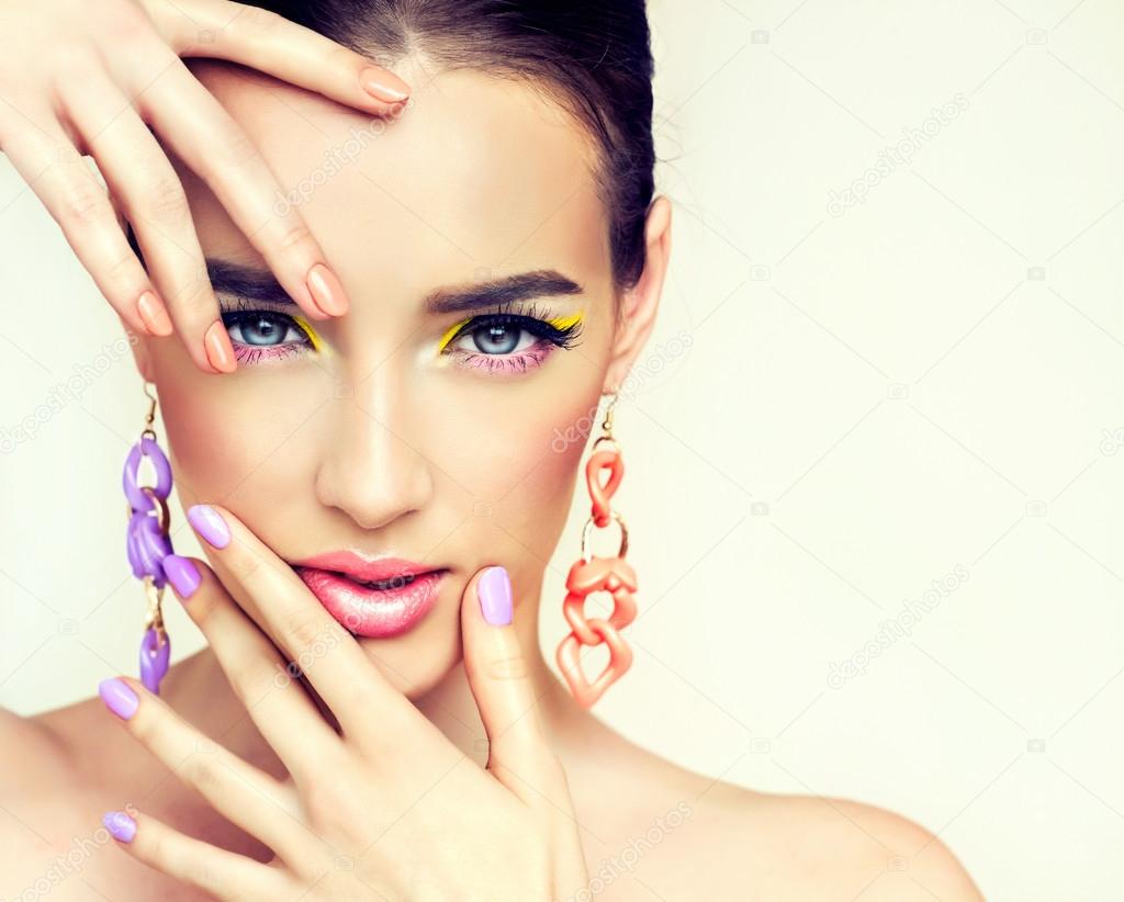 Model with bright make-up and colored nails