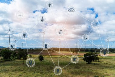 Aerial view of large wind turbines at sunrise taken from the air. wind turbines farm park. Save and green energy sustainable concept with virtual icons.