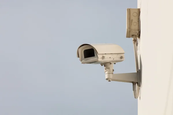 Security camera on wall of building Stock Image