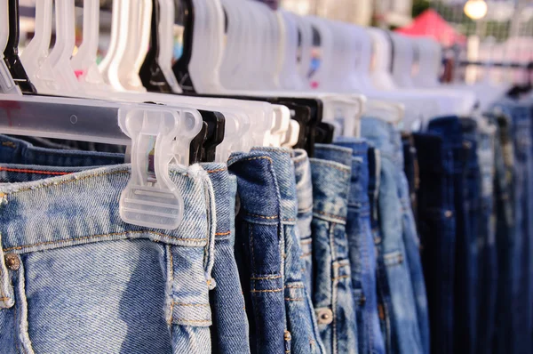 Jeans on coat hanger. selective focus. — Stock Photo, Image