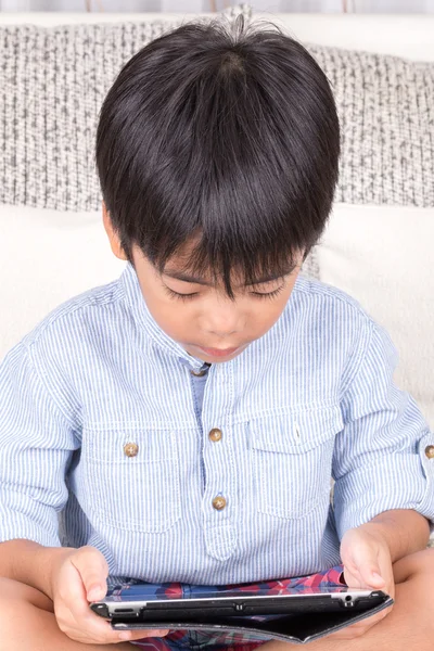 Liten pojke leker med digital tablet — Stockfoto