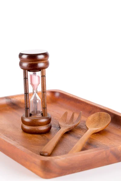 Hourglass on a plate with a fork and knife for food and time con — Stock Photo, Image