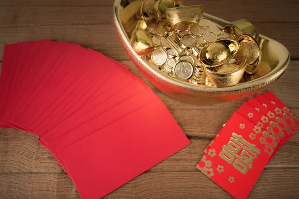 Rote Tasche und alte chinesische Goldbarren auf Holz: mit — Stockfoto