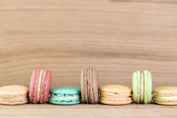 Imagem do foco da pilha de Macarons franceses coloridos no backgrou de madeira — Fotografia de Stock