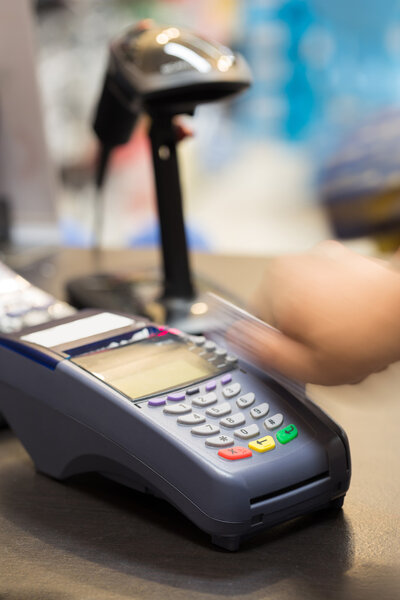 Hand Swiping Credit Card In Store