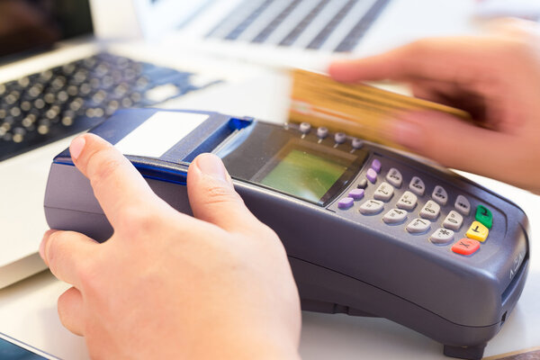 Hand Swiping Credit Card In Store : Selective Focus