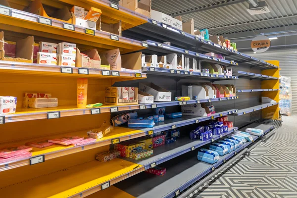 Personal hygiene products in the supermarket. Half empty shelves during the COVID-19 coronavirus epidemic. Buyers bought up tampons,  napkins, and toilet paper. Russia, Moscow, March 17, 2020