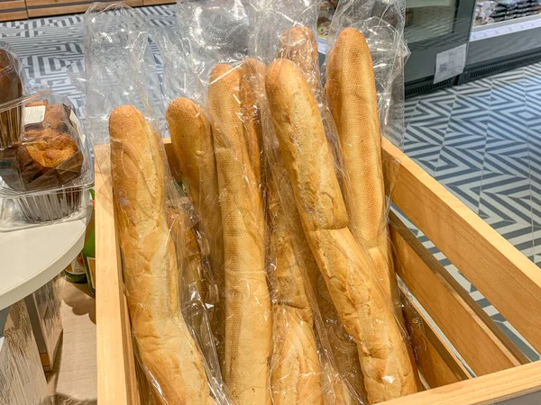 French baguettes in plastic packaging. Grocery store