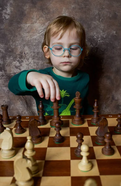 A little boy is playing chess.Chess tournament.