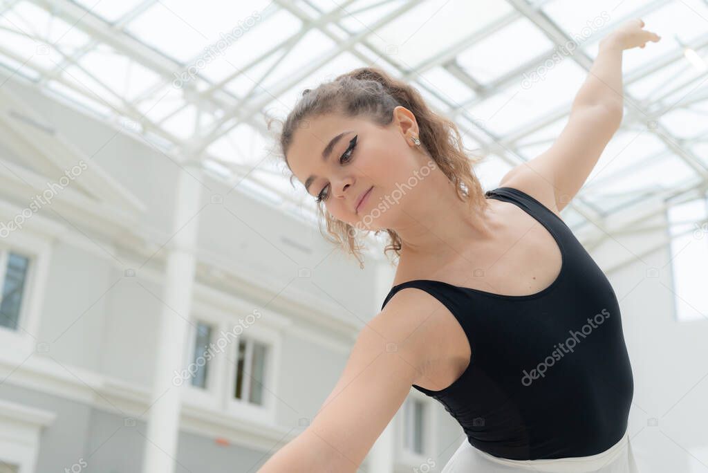 Beautiful flexible slender young girl ballerina. Ballet