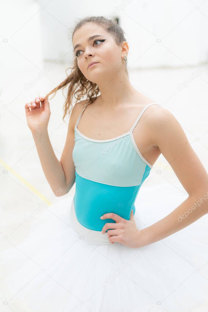 Beautiful flexible slender young girl ballerina. Ballet