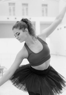 Black and white photo of flexible slender young girl ballerina. BW