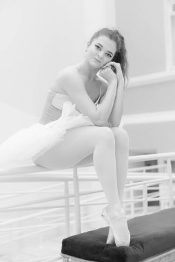 Black and white photo of flexible slender young girl ballerina. BW