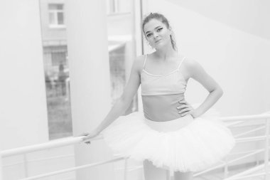 Black and white photo of flexible slender young girl ballerina. BW