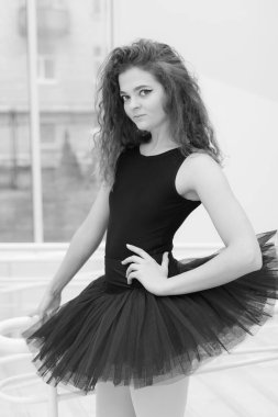 Black and white photo of flexible slender young girl ballerina. BW