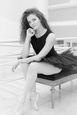 Black and white photo of flexible slender young girl ballerina. BW