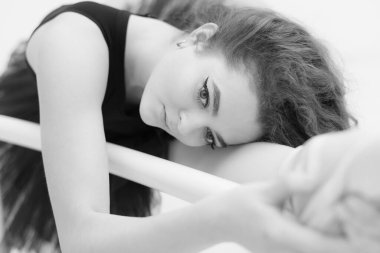 Black and white photo of flexible slender young girl ballerina. BW