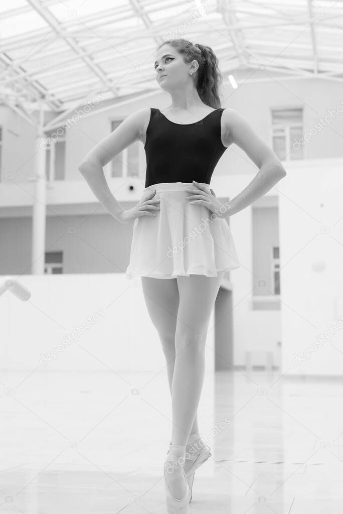 Black and white photo of flexible slender young girl ballerina. BW