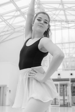 Black and white photo of flexible slender young girl ballerina. BW