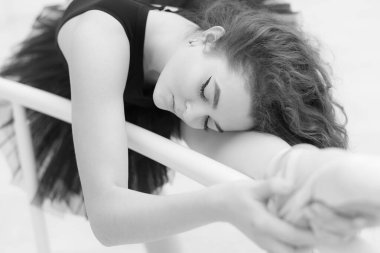 Black and white photo of flexible slender young girl ballerina. BW