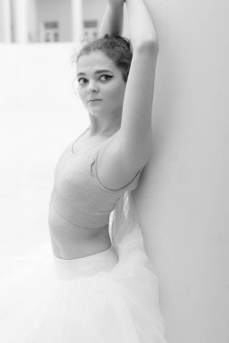 Black and white photo of flexible slender young girl ballerina. BW