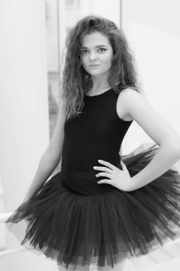 Black and white photo of flexible slender young girl ballerina. BW