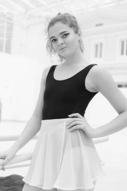 Black and white photo of flexible slender young girl ballerina. BW