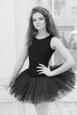 Black and white photo of flexible slender young girl ballerina. BW