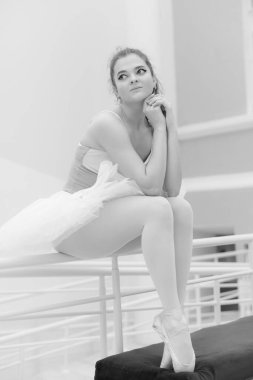 Black and white photo of flexible slender young girl ballerina. BW