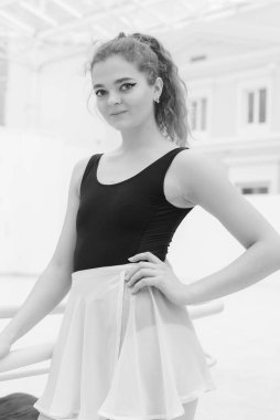 Black and white photo of flexible slender young girl ballerina. BW