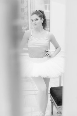 Black and white photo of flexible slender young girl ballerina. BW