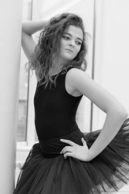 Black and white photo of flexible slender young girl ballerina. BW