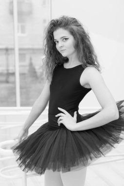 Black and white photo of flexible slender young girl ballerina. BW