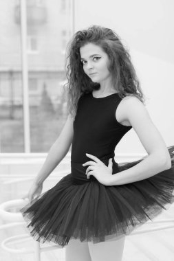 Black and white photo of flexible slender young girl ballerina. BW